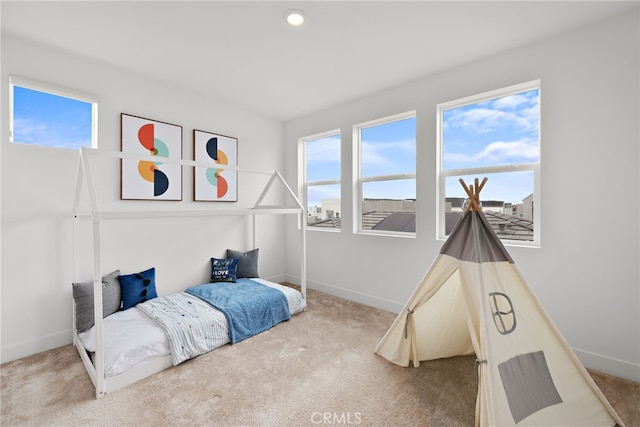 bedroom with baseboards and carpet