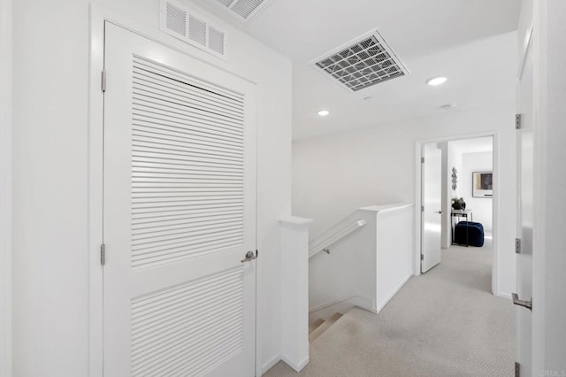 hall featuring light carpet, recessed lighting, visible vents, and an upstairs landing