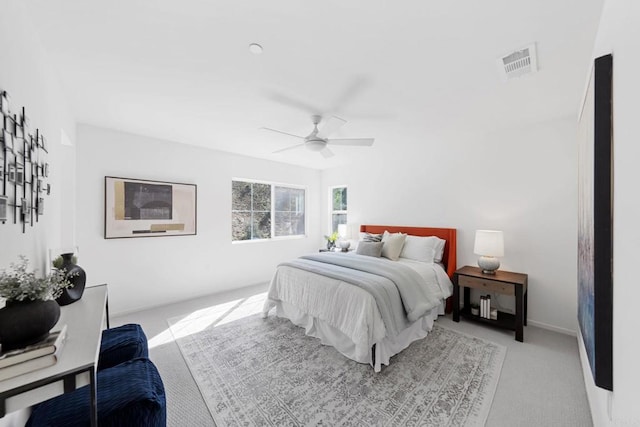 bedroom with carpet floors, visible vents, and ceiling fan