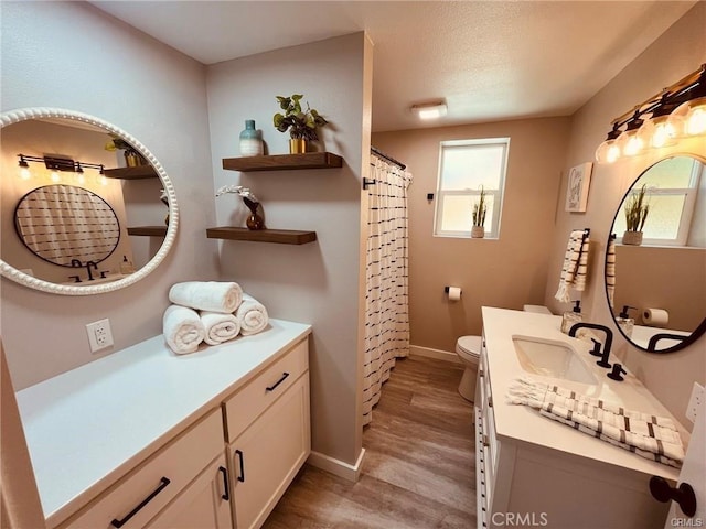 full bath with curtained shower, toilet, wood finished floors, vanity, and baseboards