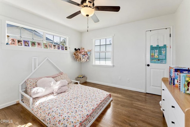 bedroom featuring a ceiling fan, baseboards, and wood finished floors