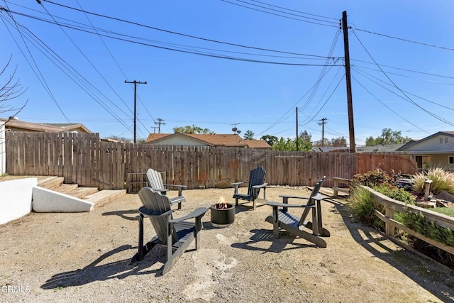 view of yard featuring fence and a fire pit