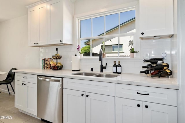 kitchen featuring white cabinets, dishwasher, and a sink