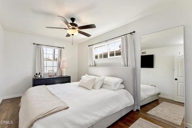 bedroom with a ceiling fan, baseboards, and wood finished floors