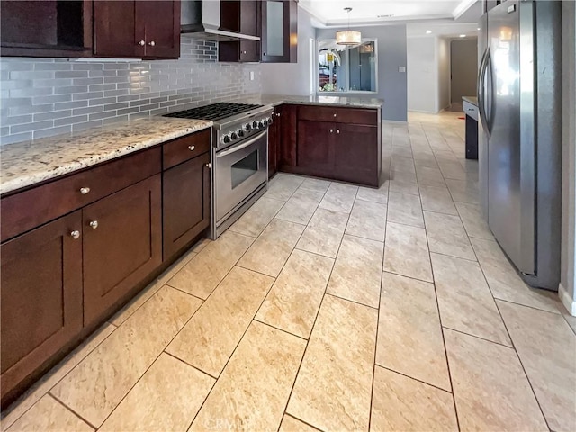 kitchen featuring light tile patterned floors, light stone counters, stainless steel appliances, a peninsula, and backsplash