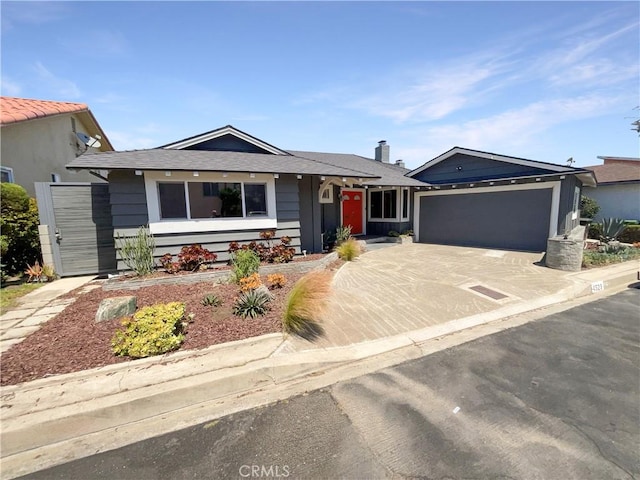 single story home with concrete driveway and an attached garage