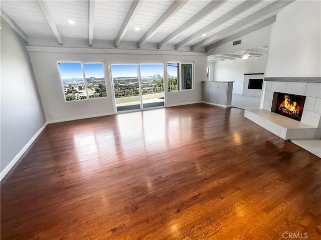 unfurnished living room with a fireplace, wood finished floors, a ceiling fan, and baseboards