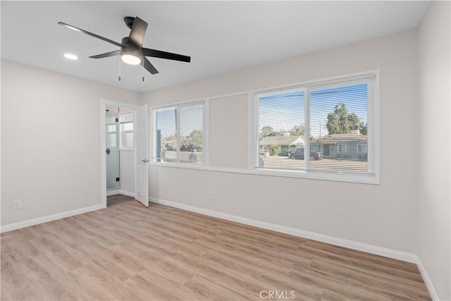 empty room with light wood-type flooring, ceiling fan, baseboards, and recessed lighting