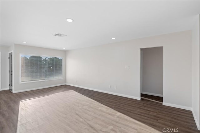 unfurnished living room featuring visible vents, baseboards, wood finished floors, and recessed lighting