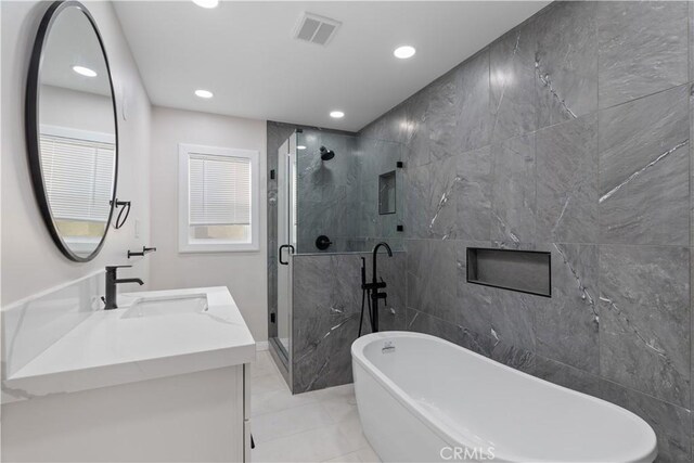 full bathroom with a freestanding tub, visible vents, a shower stall, and vanity