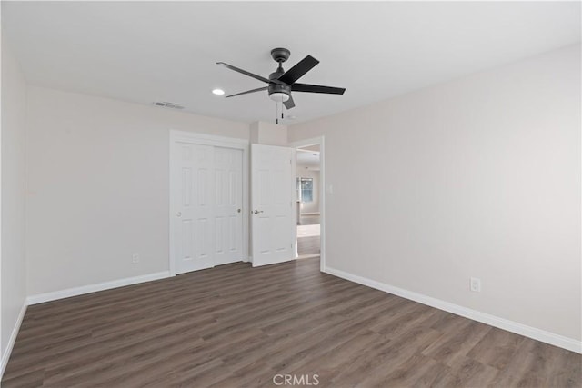 unfurnished bedroom with visible vents, baseboards, dark wood-style floors, a closet, and recessed lighting