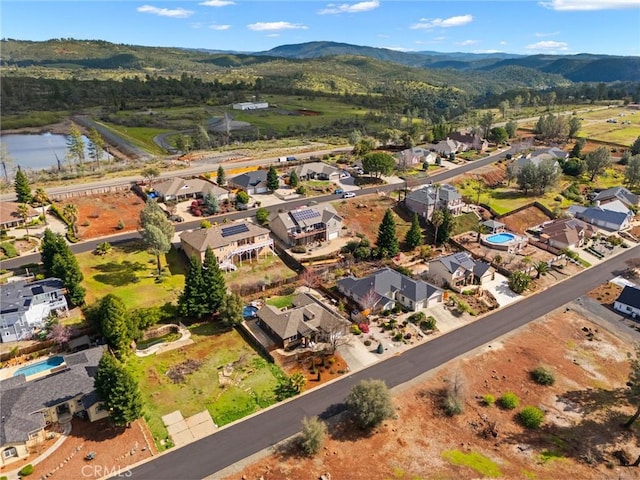 drone / aerial view with a residential view and a water and mountain view