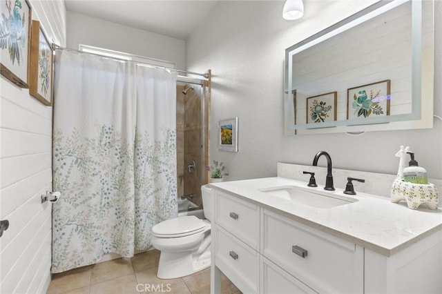 bathroom featuring shower / tub combo with curtain, vanity, toilet, and tile patterned floors