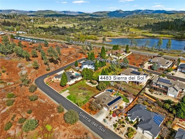 birds eye view of property with a water and mountain view