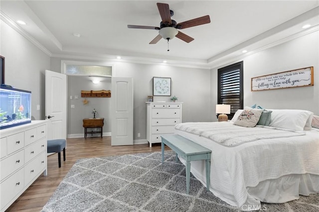 bedroom featuring baseboards, recessed lighting, wood finished floors, and crown molding