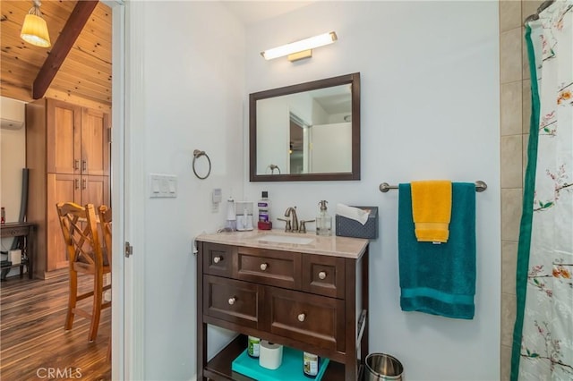 full bath featuring curtained shower, wood finished floors, wood ceiling, vanity, and beam ceiling