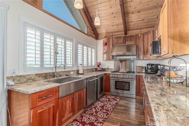 kitchen with light stone counters, lofted ceiling with beams, appliances with stainless steel finishes, a sink, and under cabinet range hood