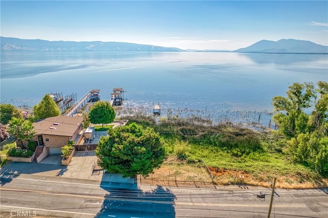 drone / aerial view with a water and mountain view