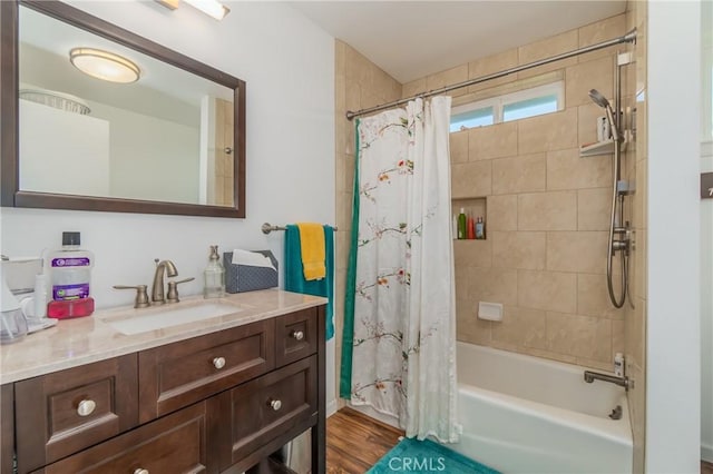 bathroom featuring shower / tub combo with curtain, vanity, and wood finished floors