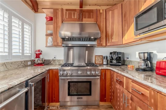 kitchen featuring beverage cooler, stainless steel appliances, ventilation hood, light stone countertops, and brown cabinetry