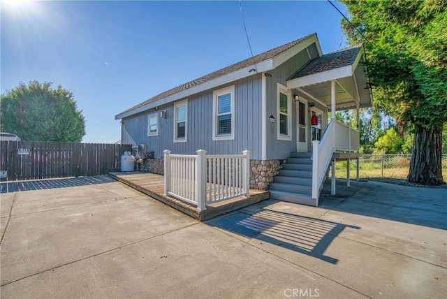 rear view of property featuring fence