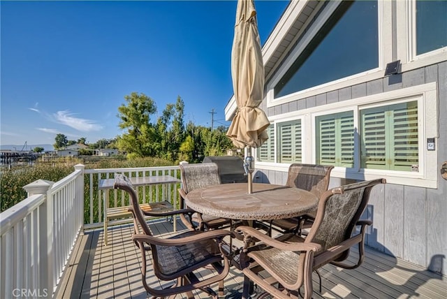 wooden deck featuring outdoor dining area