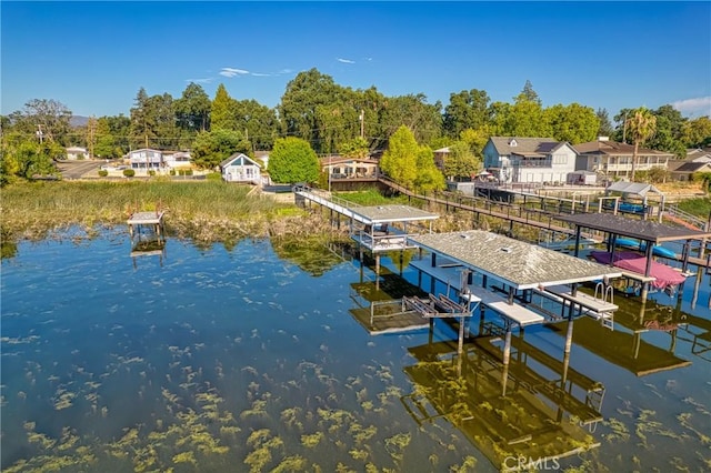 dock area featuring a residential view, a water view, and boat lift