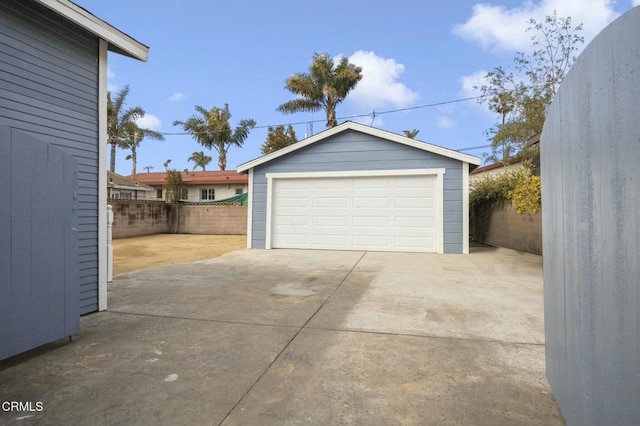 detached garage featuring fence