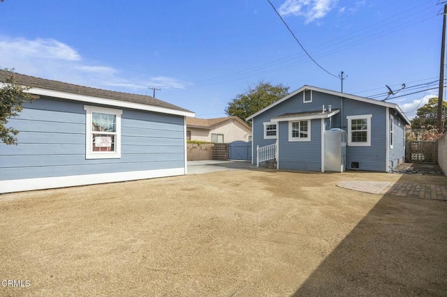 back of house with a gate and fence