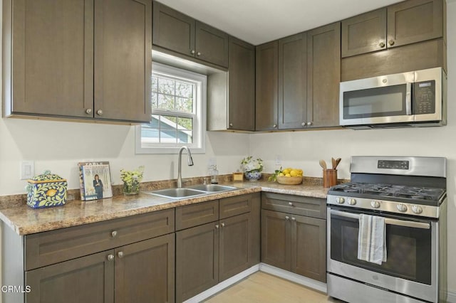 kitchen featuring appliances with stainless steel finishes and a sink