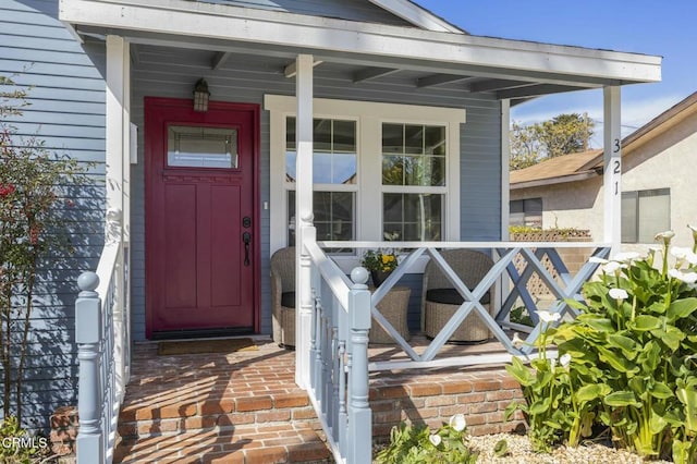 view of exterior entry with covered porch