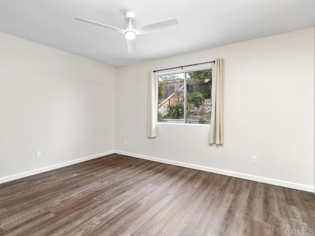 spare room with ceiling fan, baseboards, and wood finished floors