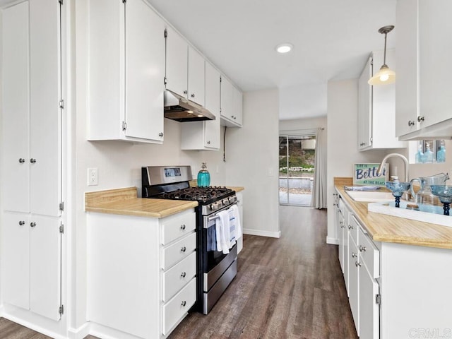 kitchen featuring dark wood-type flooring, light countertops, stainless steel range with gas stovetop, and under cabinet range hood