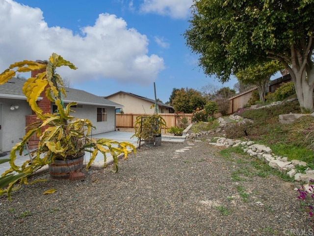 view of yard with a fenced backyard and a patio