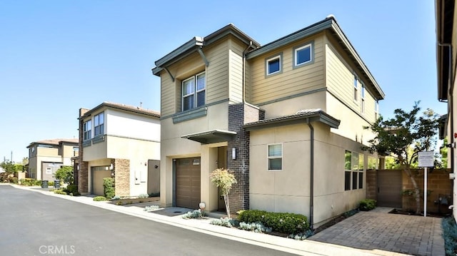 view of front of home with a garage and stucco siding