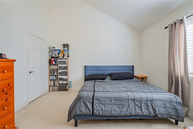 carpeted bedroom featuring lofted ceiling