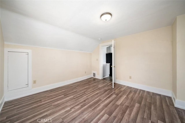 bonus room featuring lofted ceiling, wood finished floors, and baseboards