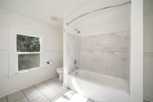 bathroom featuring tile patterned flooring, toilet, and shower / bath combination