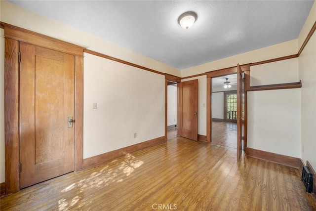 empty room featuring baseboards and light wood-style floors