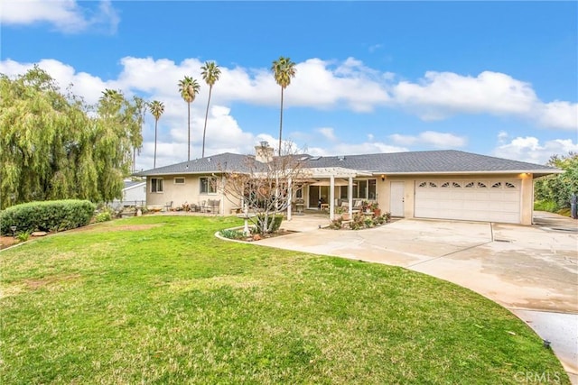 view of front of property with a garage, driveway, a front lawn, and stucco siding