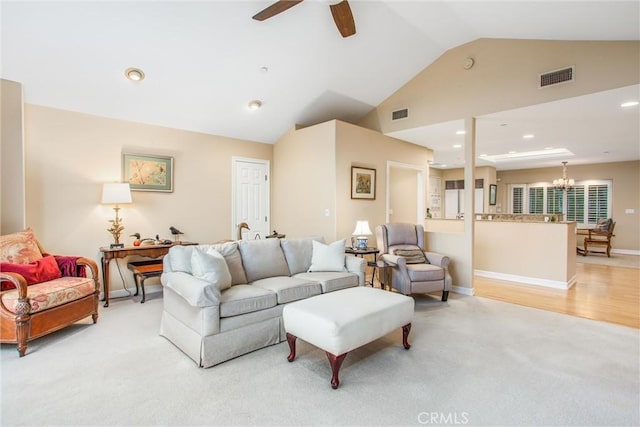 living room with light carpet, high vaulted ceiling, visible vents, and a ceiling fan