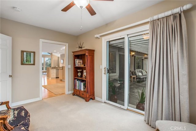 interior space featuring carpet floors, ceiling fan, and baseboards