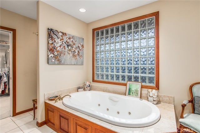 bathroom with a jetted tub and tile patterned floors