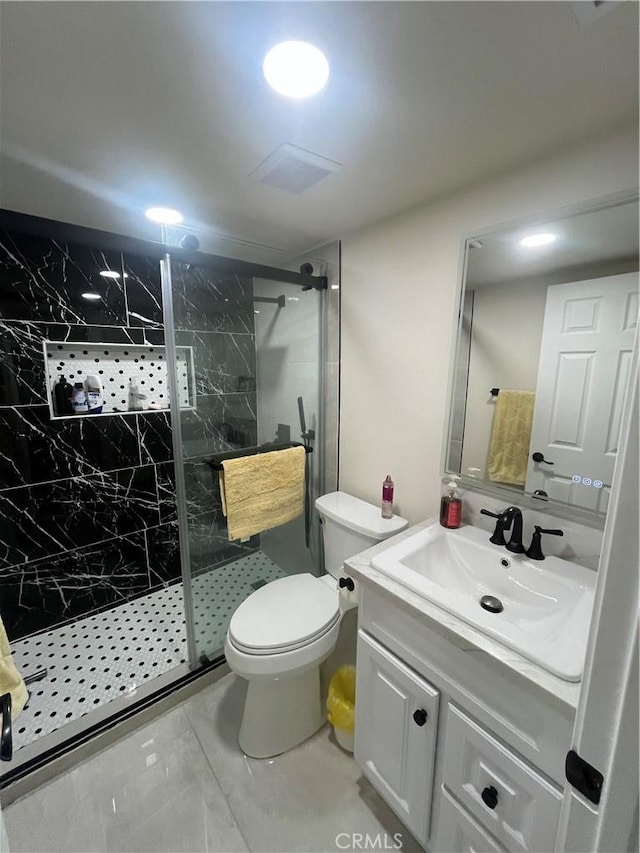 full bath with visible vents, toilet, vanity, and a marble finish shower