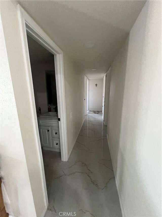 hall featuring marble finish floor and baseboards