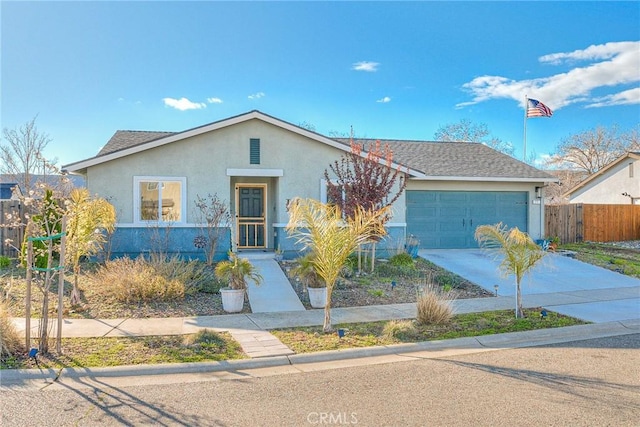 single story home with a garage, concrete driveway, roof with shingles, fence, and stucco siding