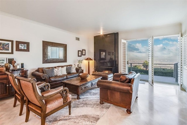 living room featuring a fireplace, visible vents, and crown molding