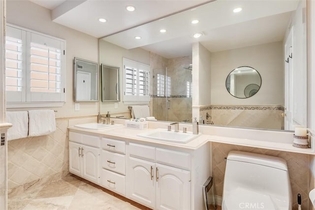 full bathroom with recessed lighting, tile walls, a sink, and a stall shower