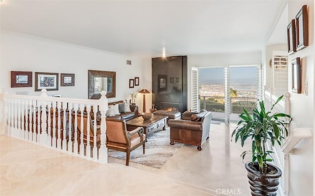 living area featuring ornamental molding and a fireplace