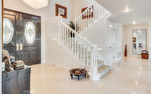 entrance foyer with visible vents, baseboards, stairway, ornamental molding, and marble finish floor